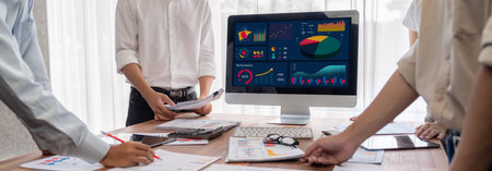 Panorama shot analyst team utilizing BI Fintech to analyze financial report with laptop....