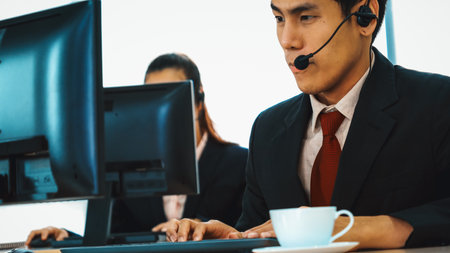 Business people wearing headset working in office to support remote customer or colleague. Call center, telemarketing, customer support agent provide service on telephone video conference call. Jivyの写真素材