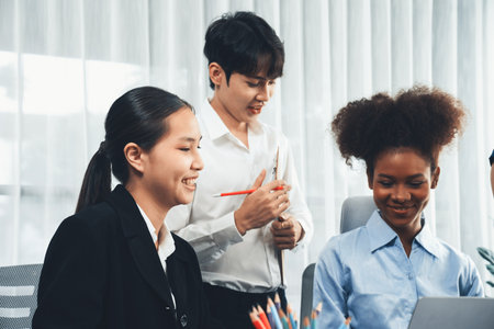 Happy diverse business people work together, discussing in corporate office. Professional and diversity teamwork discuss business plan on desk with laptop. Modern multicultural office worker. Concordの写真素材
