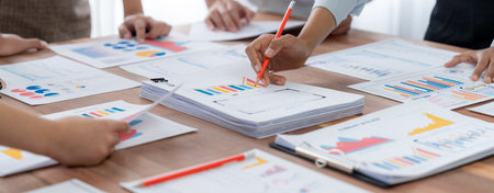 Analyst team utilizing BI Fintech to analyze and pointing at financial dashboard paper office....