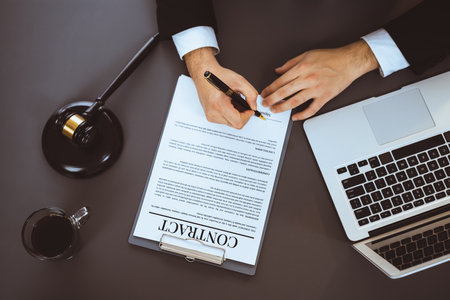 Top view lawyer signing contract, professional lawyer in law firm office drafting legal document or contract agreement ensuring lawful protection for clients dispute concept. Equilibriumの写真素材