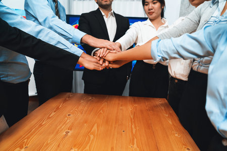 Multiracial business people make synergy hand stack together in meeting room as cooperation or team building for corporate employee in workplace. Meticulousの写真素材