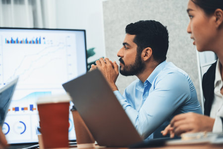 Professional Asian employee work together as team in corporate office, discussing business plans and data to achieve success on desk with laptop. Modern office worker teamwork concept. Concordの写真素材