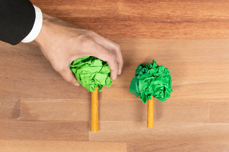 Ethical business with forest regeneration concept, top view recycle paper tree on wooden table as environmental awareness. Eco-friendly company policy and green environment effort to save Earth. Alterの写真素材