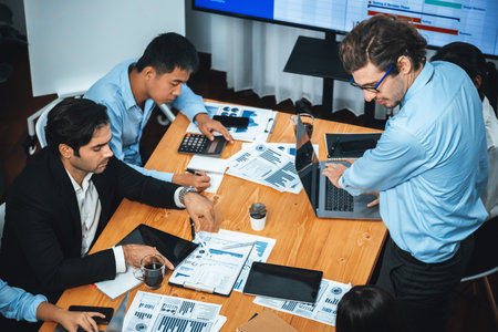 Project manager planning schedules for business task at meeting room, Gantt chart software show on TV screen. Multi ethnic diversity business people and modern business project management. Meticulousの写真素材