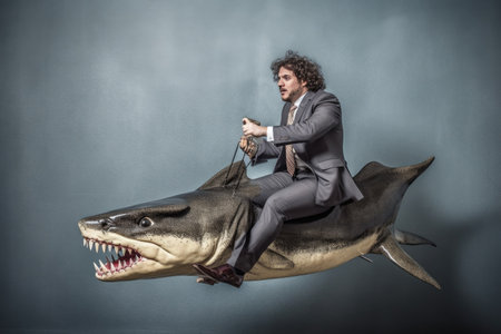 A businessman riding a shark. Generative AI AIG27.の素材