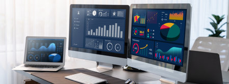 Business intelligence chart and graph display on computer monitor at corporate office. Dark blue...