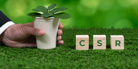 Businessman holding plant pot with cube symbolizing CSR. Ethical and eco-friendly green business with no CO2 emission policy. Committed to corporate social responsibility for greener community. Alterの写真素材