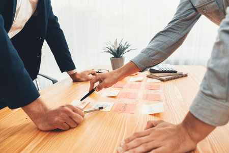 Business team gather on table, brainstorming and writing creative idea on colorful notes. Planning and brainstorm strategy to achieve business targets. ferventの写真素材