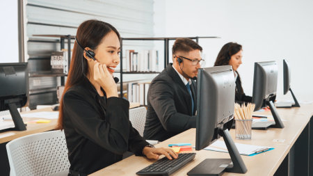 Business people wearing headset working in office to support remote customer or colleague. Call center, telemarketing, customer support agent provide service on telephone video conference call. Jivyの写真素材