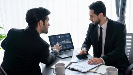 Busy analyst team discussing financial data on digital dashboard, analyzing chart and graph using data science software display on a laptop screen. Business intelligence and Fintech. Ferventの写真素材
