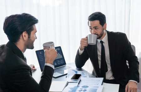 Busy analyst team discussing financial data on digital dashboard, analyzing chart and graph using data science software display on a laptop screen. Business intelligence and Fintech. Ferventの写真素材