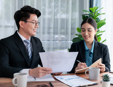 Busy analyst team in office discuss data analysis and marketing strategy using BI dashboard and statistics to improve business performance at corporate meeting with successful teamwork. Jubilantの写真素材