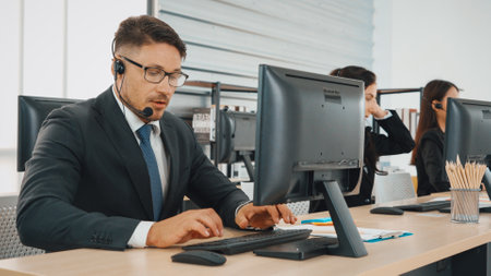 Business people wearing headset working in office to support remote customer or colleague. Call center, telemarketing, customer support agent provide service on telephone video conference call. Jivyの写真素材