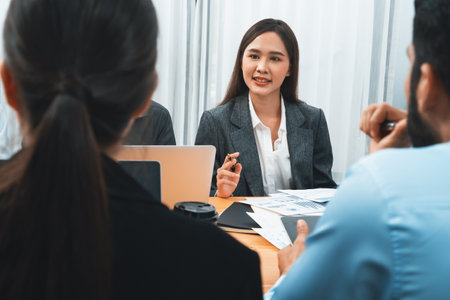 Multiracial analyst team use BI dashboard data to analyze financial report on meeting table. Group of diverse business people utilize data analysis by FIntech for business marketing decision. Concordの写真素材