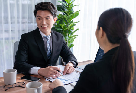 Busy analyst team in office discuss data analysis and marketing strategy using BI dashboard and statistics on laptop screen to improve business performance at meeting with strong teamwork. Jubilantの写真素材