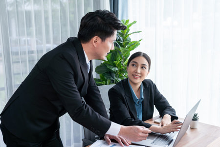 Busy analyst team in office discuss data analysis and marketing strategy using BI dashboard and statistics on laptop screen to improve business performance at meeting with strong teamwork. Jubilantの写真素材