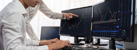 Group of traders discussing on office desk, monitoring stock market on monitor at office workplace....