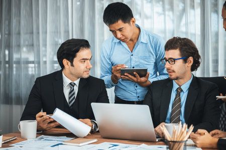 Diverse of business people from various ethnic group working in modern office environment. Productive and multi ethnic office workers engage in discussion for strategic business marketing. Meticulousの写真素材