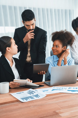 Multiracial analyst team use BI dashboard data to analyze financial report on meeting table. Group of diverse business people utilize data analysis by FIntech for success business marketing. Concordの写真素材