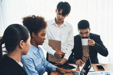 Multiracial analyst team use BI dashboard data to analyze financial report on meeting table. Group of diverse business people utilize data analysis by FIntech for business marketing decision. Concordの写真素材