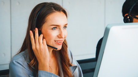 Business people wearing headset working in office to support remote customer or colleague. Call center, telemarketing, customer support agent provide service on telephone video conference call. Jivyの写真素材