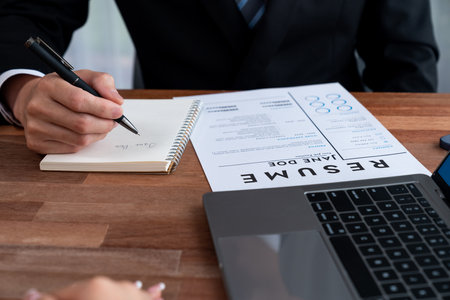 Conversational job interview between interviewer and candidate. HR manager asking about candidate qualifications and application for job position with resume. Job employment for applicant. Jubilantの写真素材