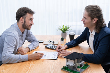 Client and real estate agent review loan contract, discussing term, interest rate, and property ownership. Analyze legal document and thoroughly read agreement before making decision. Entityの写真素材