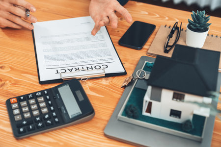 Real estate agent calculating tax and interest, insurance agreement terms with client buying property and applying for house loan. Financial advisor managing investment budget with calculator. Entityの写真素材