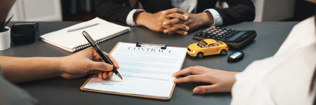 Customer client signs the contract with the agent or car dealer after successful car loan or purchasing a new car. Auto insurance and finance agreements. Prodigyの写真素材