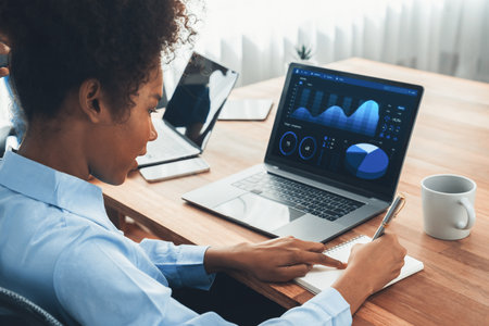 Young african businesswoman working together and discussing in corporate office with multicultural coworkers. Professional and diversity teamwork discuss business plan on desk. Concordの写真素材