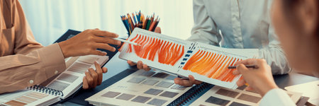 Group of interior designer team in meeting, discussing with engineer on interior design and planning for house project blueprint and model, choosing various mood board materials. Insightの写真素材