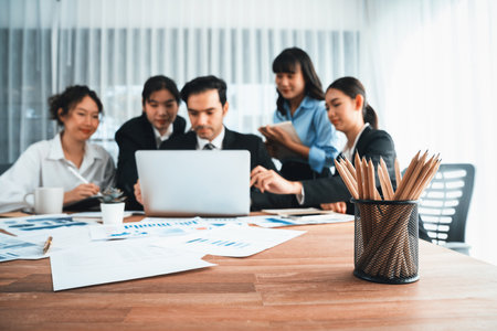 Focus financial data dashboard paper by business intelligence display graph, chart and statistic report on office table with blurred business people working in background. Habilimentの写真素材
