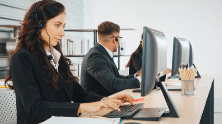 Business people wearing headset working in office to support remote customer or colleague. Call center, telemarketing, customer support agent provide service on telephone video conference call. Jivyの写真素材