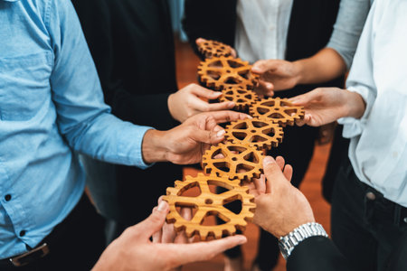 Group of multiracial business people joining gear wheels together as effective unity and productive teamwork concept. Efficient system business team process for solution solving. Meticulousの写真素材