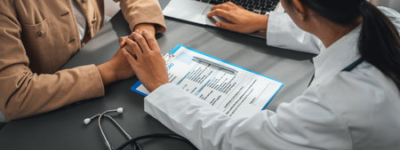Doctor show medical diagnosis report and providing compassionate healthcare consultation while holding young patient hand for being supportive and professional in doctor clinic office. Neotericの写真素材