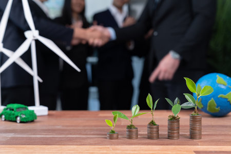 Organic money growth investment concept shown by stacking piles of coin with sprout or baby plant on top. Financial investments rooted and cultivating sustainable clean energy with nature. Quaintの写真素材