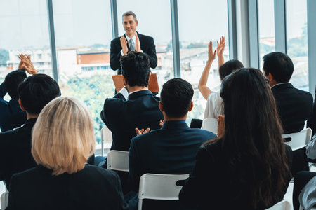 Group of business people meeting in a seminar conference . Audience listening to instructor in employee education training session . Office worker community summit forum with expert speaker . Jivyの写真素材