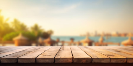 The empty wooden brown table top with blur background of seaside resort. Exuberant image.の写真素材
