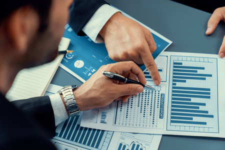 Closeup busy analyst team discussing financial data on digital dashboard, analyzing chart and graph using data science software display on a laptop screen. Business intelligence and Fintech. Ferventの写真素材