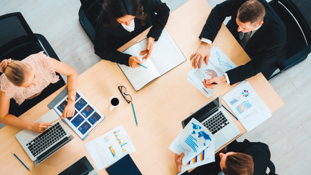 Business people group meeting shot from top view in office . Profession businesswomen, businessmen and office workers working in team conference with project planning document on meeting table . Jivyの写真素材