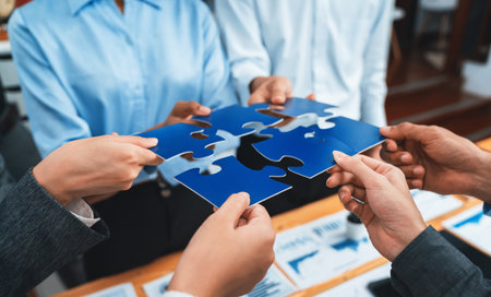 Corporate officer worker collaborate in office, connecting puzzle pieces with report paper on table...