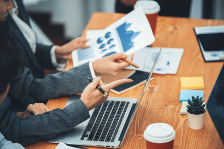 Multiracial analyst team use BI dashboard data to analyze financial report on meeting table. Group of diverse business people utilize data analysis by FIntech for business marketing decision. Concordの写真素材
