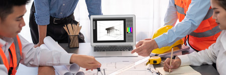 Engineer and architect working together brainstorming and designing blueprint using laptop working with architectural software for precise digital interior or structure design. Insightの写真素材