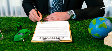 Businessman or CEO in office signing environmental regulation agreement to save Earth with sustainable energy utilization and CO2 reduction for greener future. Quaintの写真素材