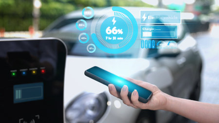 Modern businessman check battery status from smartphone mobile 3D hologram while his EV car...