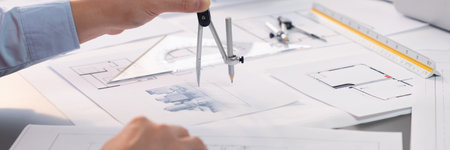 Architect or engineer working on building blueprint, contractor designing and drawing blueprint...