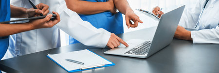 Doctor and nurse in medical meeting discussing strategic medical treatment plan together with report...