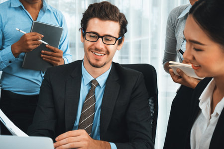 Diverse of business people from various ethnic group working in modern office environment. Productive and multi ethnic office workers engage in discussion for strategic business marketing. Habilimentの写真素材