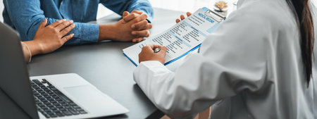 Doctor providing compassionate healthcare consultation while young couple patient holding hand, comfort each other after infertile report. Reproductive and medical fertility consulting. Neotericの写真素材